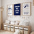 Three framed nursery wall art prints hang above a wooden storage bench in a styled children's room. The center print is navy blue with white text reading 'DREAM BIG LITTLE ONE,' while the left and right prints are white with navy text reading 'I WANTED A TWINKLE LITTLE STAR' and 'I LOVE YOU TO THE MOON AND BACK FOREVER & EVER.