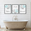 Set of 3 bathroom wall art prints in light teal and grey featuring butterflies and the words "Relax", "Soak", and "Unwind" – perfect spa-inspired decor for a calming, minimalist bathroom or home spa.