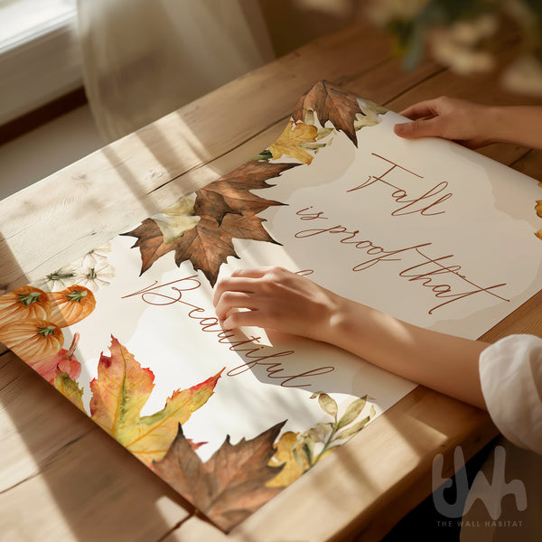Person holding a decorative paper with autumn-themed design and text on a wooden surface.