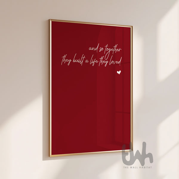 Framed red poster with white text on a white wall
