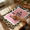 Pink motivational wall art reading “Be You The World Will Adjust” with leopard print and bold zebra pattern details.