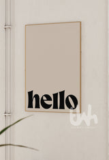 Framed artwork with 'hello' text on a neutral wall.