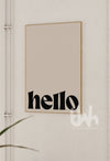 Framed artwork with 'hello' text on a neutral wall.