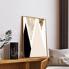 Abstract art piece on a wall with a plant and pillow in the foreground