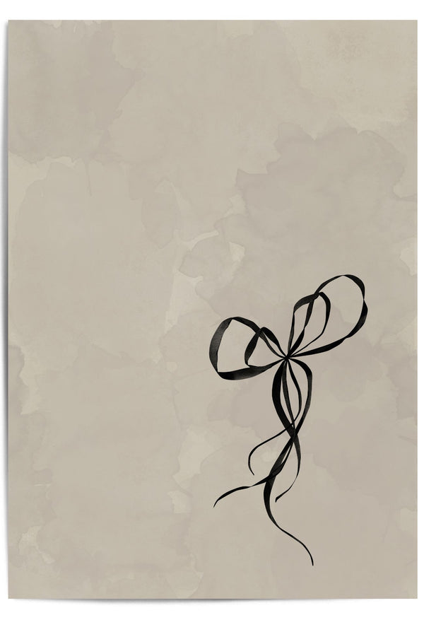 Flat-lay of a beige and black minimalist bow print – elegant wall art for soft neutral interiors