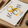 Close-up of a personalized family wall print with a bold yellow S monogram, black script surname 'Stephens', and family members’ names in all caps