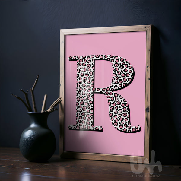 Personalised leopard print initial wall art with pink background displayed in a modern interior