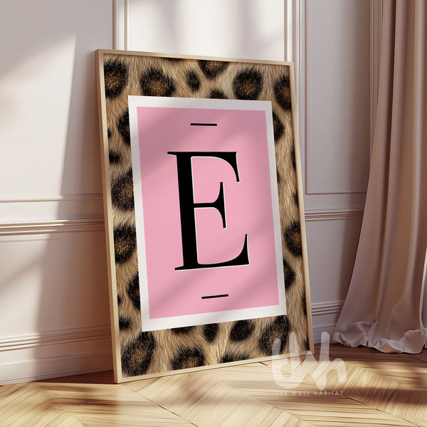 Personalised pink leopard initial wall art print featuring a bold letter on a blush background in a gold frame.