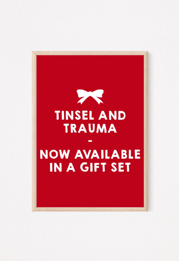 Red poster with tinsel and trauma festive quote