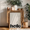 Wooden cabinet with decorative items and a 'hello' poster in a home setting