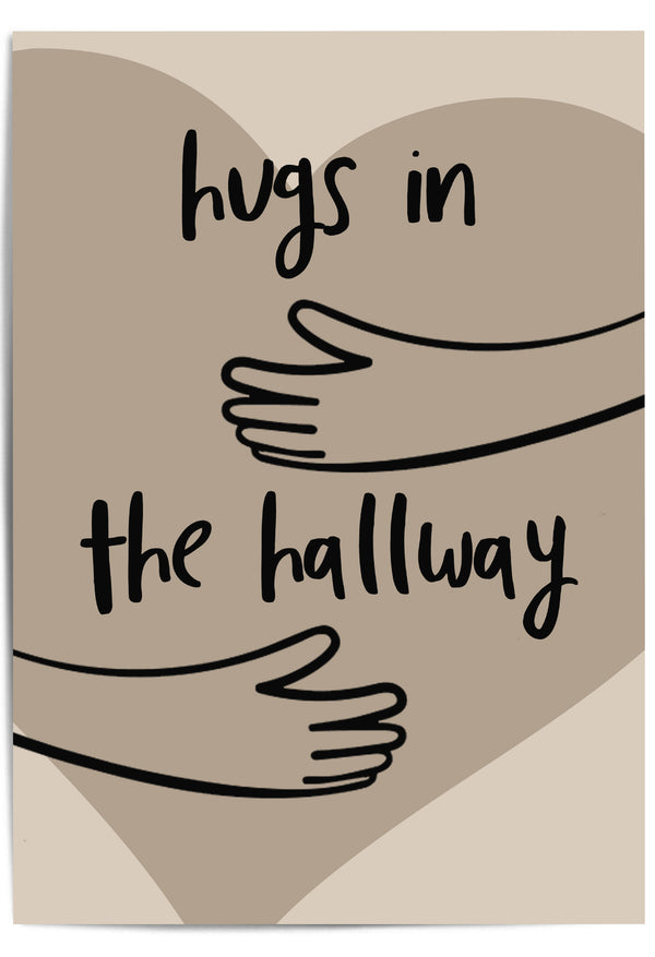 Neutral-toned wall art print leaning against a wooden door in a cozy hallway, featuring minimalist line art of arms and the phrase 'Hugs in the Hallway' over a heart shape
