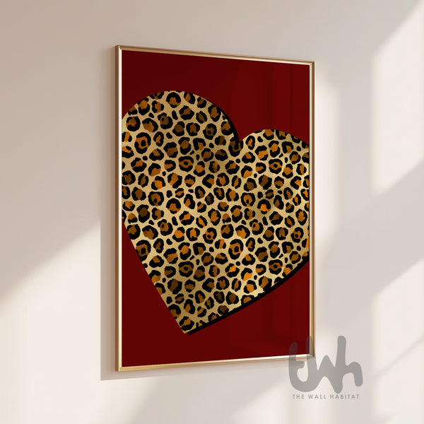 Leopard heart wall art print with gold leopard pattern on a deep red background displayed in a modern gold frame