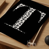 Personalized monogram wall art featuring a bold serif letter 'T' in black and white leopard print on a solid black background, styled on a wooden tray