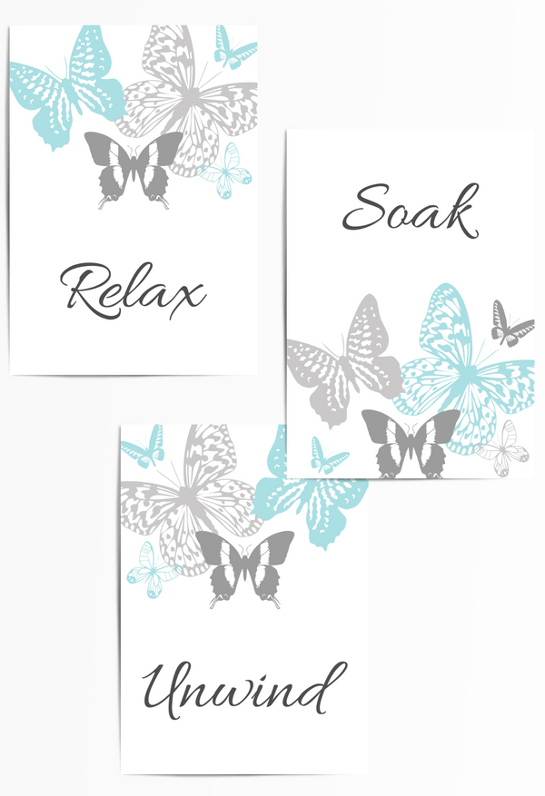 Set of 3 bathroom wall art prints in light teal and grey featuring butterflies and the words "Relax", "Soak", and "Unwind" – perfect spa-inspired decor for a calming, minimalist bathroom or home spa.