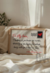 Framed love quote wall art print styled on a cozy cream bed with natural light – romantic bedroom décor idea
