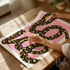 Pink leopard print wall art featuring the word love in bold leopard typography, modern fashion inspired home decor print