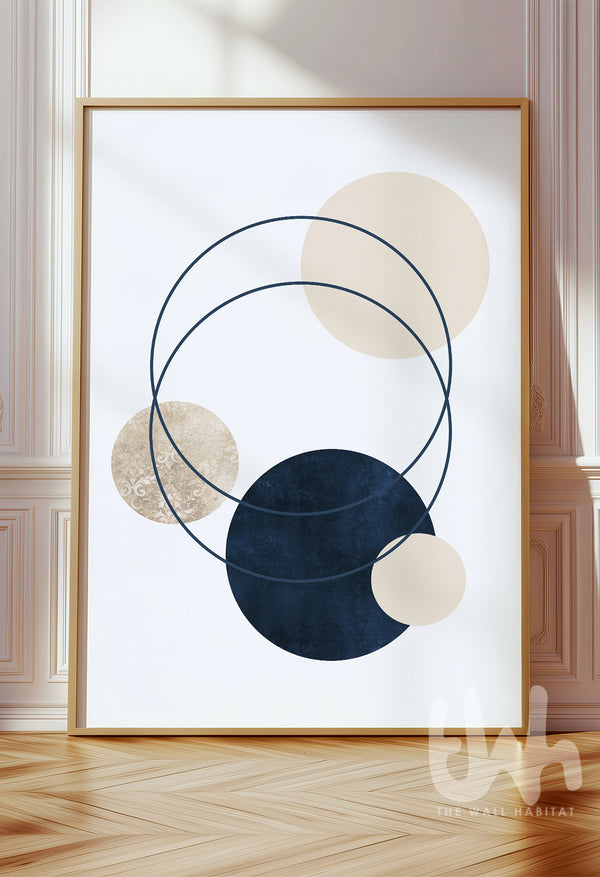 Abstract wall art with overlapping navy, beige, and cream circles and thin intersecting rings, framed and styled in a modern minimalist interior.