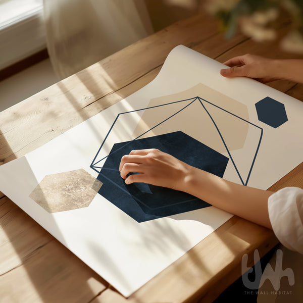 Person holding a geometric design paper on a wooden table