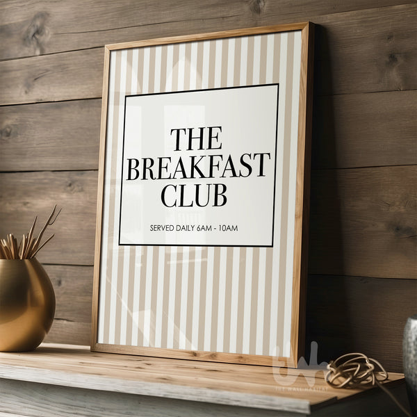 Framed print titled 'The Breakfast Club' on a wooden shelf with a wooden wall background.