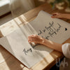 Close-up of romantic neutral wall print saying “And so together they built a life they loved” on soft beige background
