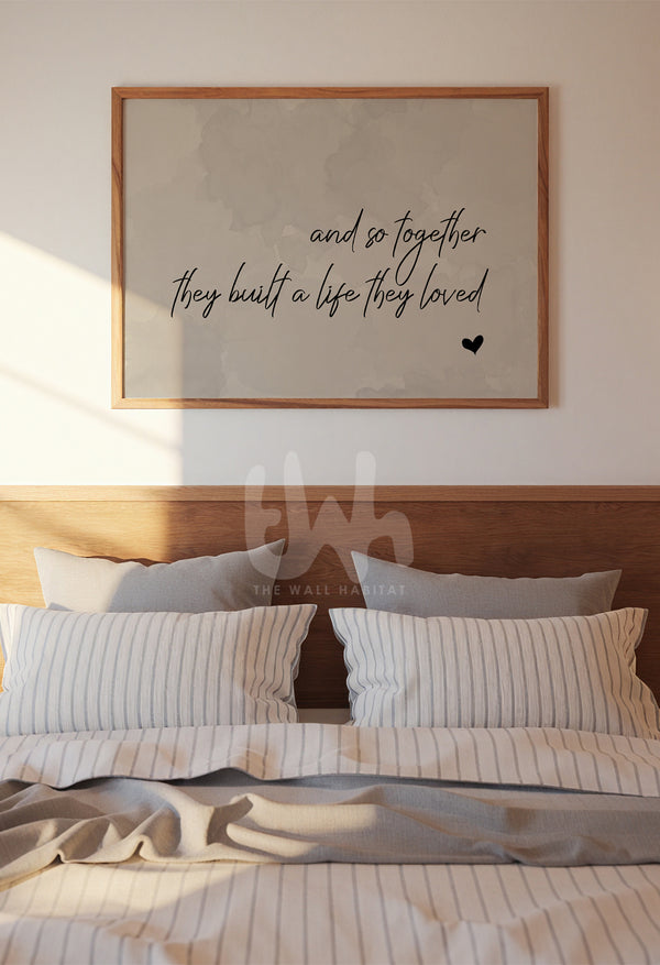 Framed quote print above a cozy bed in a minimal bedroom setting