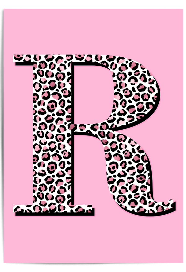 Personalised leopard print initial wall art with pink background displayed in a modern interior