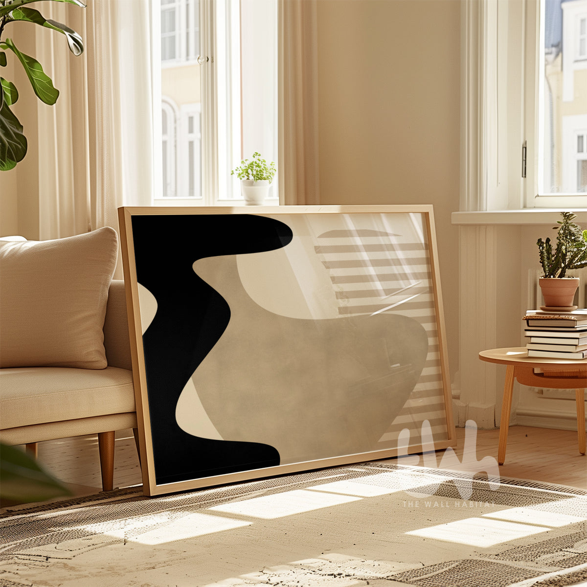 Abstract art piece in a modern living room with a beige sofa and large windows.