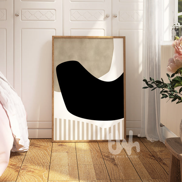 Framed abstract art piece on a wall in a room with wooden floor and white curtains.