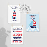 Three nautical-themed art prints for kids, clipped to a light gray wall. The prints feature illustrations of a lighthouse and a sailboat with inspirational quotes: 'LET YOUR LIGHT SHINE', 'LET YOUR DREAMS SET SAIL', and 'IF YOU WANT TO KNOW HOW MUCH WE LOVE YOU COUNT ALL THE WAVES IN THE SEA'.