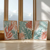 Set of 3 tropical botanical wall art prints in coral peach and teal, featuring modern leaf illustrations with a coastal and boho aesthetic – perfect for living room, bedroom, or office decor.
