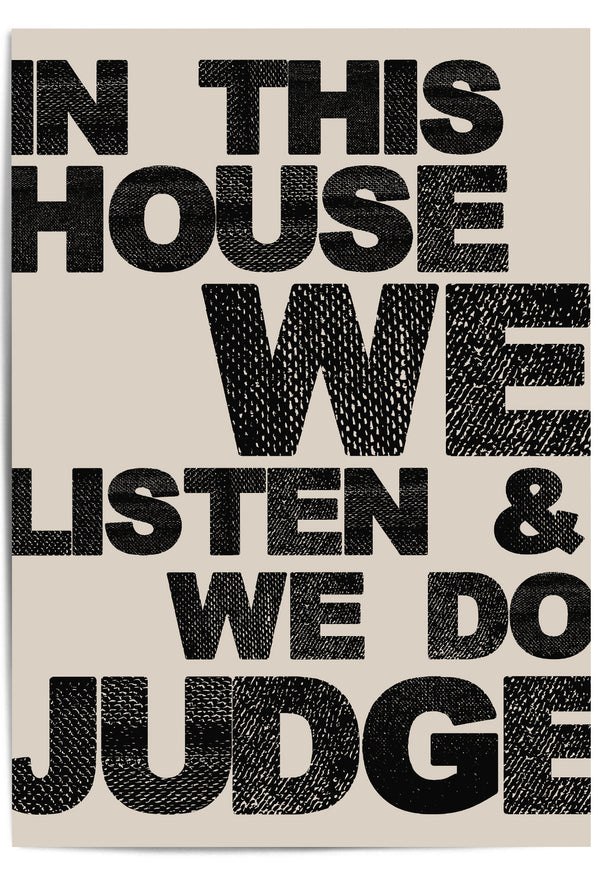 Close-up of "In This House We Listen & We Do Judge" bold typographic wall art on neutral background