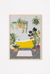Framed yellow bath wall art styled on a white console with neutral decor and pampas grass
