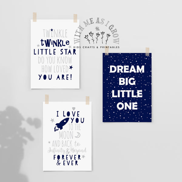 Three children's wall art prints clipped to a light gray wall. The top-left print is white with navy text reading 'Twinkle twinkle little star do you know how loved you are!'.