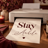 Stay Awhile digital wall art emerging from home printer