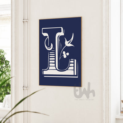 Personalized floral monogram wall art featuring a detailed white letter 'L' with botanical elements on a navy blue background, displayed in a frame