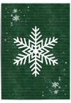 White snowflake wall art on forest green textured background