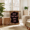Decorative sign with leopard print border and text in a living room setting