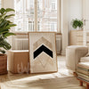 Modern living room with a geometric art piece on a wooden stand.