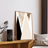Abstract art piece on a wall with a plant and pillow in the foreground