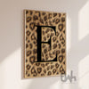 Black initial letter wall art with luxury leopard print background displayed as a modern statement poster