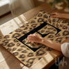 Black initial letter wall art with luxury leopard print background displayed as a modern statement poster