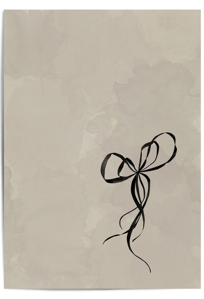 Flat-lay of a beige and black minimalist bow print – elegant wall art for soft neutral interiors