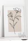 Minimalist botanical line art print featuring two abstract flowers drawn in black continuous line style over a neutral beige background, framed and styled for modern interior decor