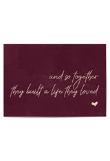 Burgundy quote wall art with champagne-gold lettering and romantic life quote