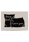 Minimalist wall art print featuring two black pillows with the phrase ‘Dear Bed, I Love You’ written in script, on a beige background