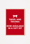 Red poster with tinsel and trauma festive quote