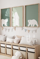 Set of three framed sage green polar bear wall art prints hanging above a toy storage bench in a neutral kids’ room