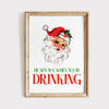 He Sees You When You're Drinking Christmas wall art with retro Santa illustration in rustic wooden frame