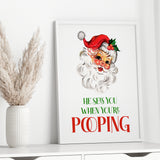 Funny Christmas bathroom wall art with vintage Santa and He Sees You When You're Pooping quote in a white frame