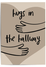 Neutral-toned wall art print leaning against a wooden door in a cozy hallway, featuring minimalist line art of arms and the phrase 'Hugs in the Hallway' over a heart shape